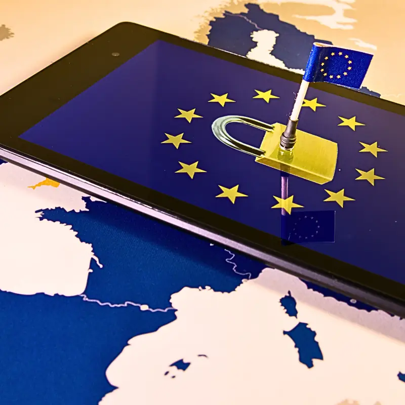 gdpr-blockchain-farm-data-compliance Tablet showing EU flag and padlock on a map of Europe, symbolizing the regulatory challenges of monetizing farm data with blockchain under GDPR.